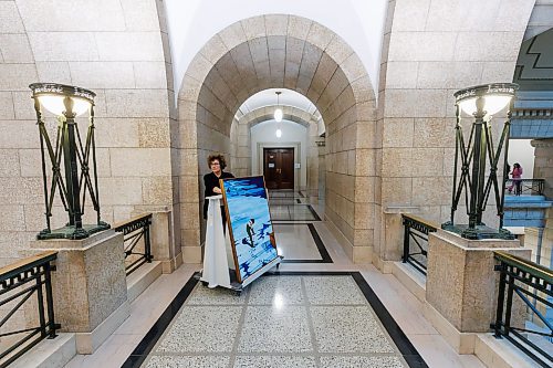 MIKE DEAL / WINNIPEG FREE PRESS
Amy Karlinsky, Visual Arts Consultant, Sport Culture Heritage and Tourism, transports a painting by Ilona Stanley, titled &#x201c;Winter Wind,&#x201d; through the halls of the Manitoba Legislative Building.
231207 - Thursday, December 07, 2023.