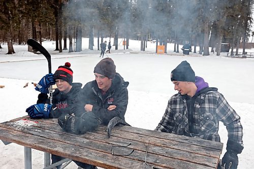 02012024
Hudson Andres, Reese Andres and Jackson Lee take a break while playing shinny with family at the skating rink and trail in Wasagaming on a mild Tuesday afternoon.
(Tim Smith/The Brandon Sun)