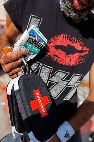 MIKE DEAL / WINNIPEG FREE PRESS
A participant with Naloxone kits and some baseball cards at Sunshine House RV or MOPS (Mobile Overdose Prevention Site) in the parking lot of 631 Main Street.
See Malak Abas and Katrina Clarke story
230816 - Wednesday, August 16, 2023.