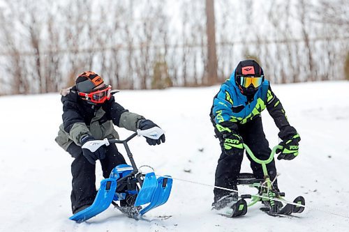 03012024
Theo Durnin and Jason Cory are pulled through the snow on sleds by Jason’s dad Ken using a quad at the Corys' home near Wawanesa on a mild and overcast Wednesday.
(Tim Smith/The Brandon Sun)