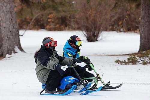 03012024
Theo Durnin and Jason Cory are pulled through the snow on sleds by Jason’s dad Ken using a quad at the Corys' home near Wawanesa on a mild and overcast Wednesday.
(Tim Smith/The Brandon Sun)