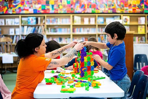 MIKAELA MACKENZIE / WINNIPEG FREE PRESS
	
Caven Brazil (seven, right), builds a structure with gears with his babysitter, Marley Woods, at the Young Designer Program at Weston School on Wednesday, Dec. 13, 2023. For Maggie story.
Winnipeg Free Press 2023