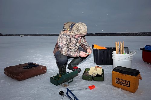 03012024
Roger Boulet of Brandon changes lures while ice-fishing at Pelican Lake with his daughter Genevieve Boulet on a mild and overcast Wednesday. Genevieve lives in Quebec and is home to visit family. The Boulet&#x2019;s also fished on the Souris River earlier in the week. 
(Tim Smith/The Brandon Sun)