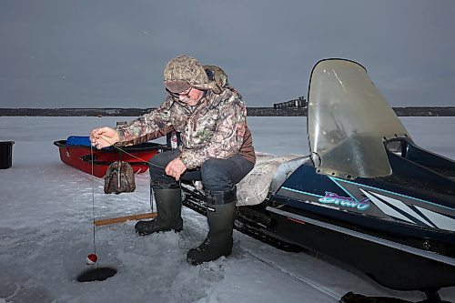 03012024
Roger Boulet of Brandon sits atop his 1994 Yamaha Bravo snowmobile while ice-fishing at Pelican Lake with his daughter Genevieve Boulet on a mild and overcast Wednesday. Genevieve lives in Quebec and is home to visit family. The Boulet&#x2019;s also fished on the Souris River earlier in the week. 
(Tim Smith/The Brandon Sun)
