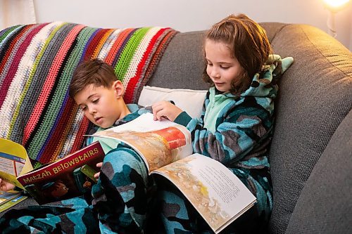 MIKAELA MACKENZIE / WINNIPEG FREE PRESS
	
Asher (eight, left), and Zev (six) Paul read books from the PJ Library (a program run by the Jewish Federation of Winnipeg which provides free books to Jewish families) at their home on Wednesday, Jan. 3, 2024.   For John Longhurst story.
Winnipeg Free Press 2023