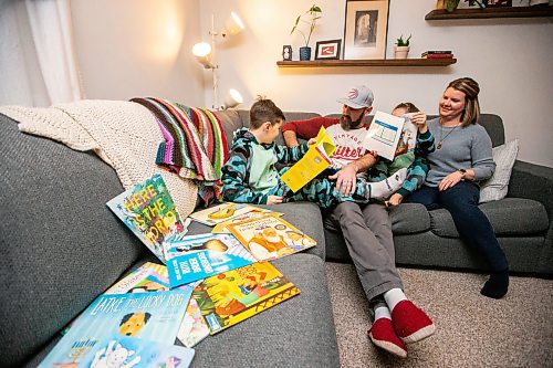 MIKAELA MACKENZIE / WINNIPEG FREE PRESS
	
Asher (eight, left), Ryan, Zev (six), and Amanda Paul read books from the PJ Library (a program run by the Jewish Federation of Winnipeg which provides free books to Jewish families) at their home on Wednesday, Jan. 3, 2024.   For John Longhurst story.
Winnipeg Free Press 2023