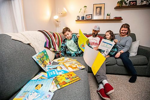 MIKAELA MACKENZIE / WINNIPEG FREE PRESS
	
Asher (eight, left), Ryan, Zev (six), and Amanda Paul read books from the PJ Library (a program run by the Jewish Federation of Winnipeg which provides free books to Jewish families) at their home on Wednesday, Jan. 3, 2024.   For John Longhurst story.
Winnipeg Free Press 2023