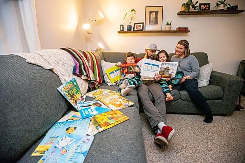 MIKAELA MACKENZIE / WINNIPEG FREE PRESS
	
Asher (eight, left), Ryan, Zev (six), and Amanda Paul read books from the PJ Library (a program run by the Jewish Federation of Winnipeg which provides free books to Jewish families) at their home on Wednesday, Jan. 3, 2024.   For John Longhurst story.
Winnipeg Free Press 2023