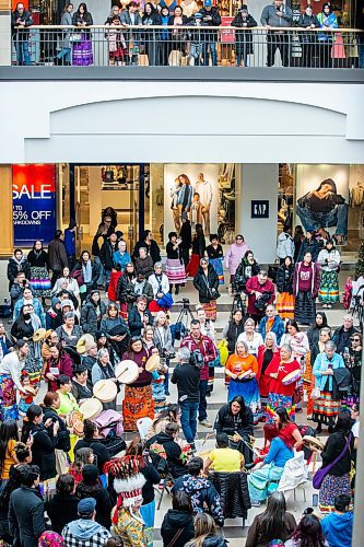 MIKAELA MACKENZIE / WINNIPEG FREE PRESS
	
The Soaring Eagle Singers lead a celebration song at Polo Park during an event marking the second annual National Ribbon Skirt Day on Thursday, Jan. 4, 2024.  Standup.
Winnipeg Free Press 2023