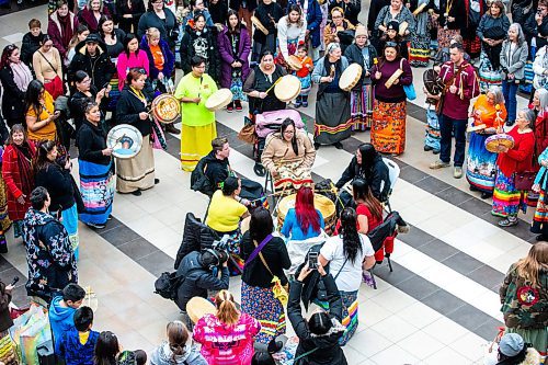 MIKAELA MACKENZIE / WINNIPEG FREE PRESS
	
The Soaring Eagle Singers lead a celebration song at Polo Park during an event marking the second annual National Ribbon Skirt Day on Thursday, Jan. 4, 2024.  Standup.
Winnipeg Free Press 2023