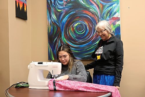 04012024
With help from Brandon University Anishinaabe Knowledge Keeper Barb Blind, university student Cari Trout of Cross Lake First Nation sews a ribbon skirt at the BU Indigenous Peoples&#x2019; Centre on Ribbon Skirt Day, Thursday. According to Blind, who has sewn traditional skirts since the mid 1990&#x2019;s, the skirts represent the power of Indigenous women and their connection to the earth. Ribbon Skirt Day is honoured on January 4th and the BU Indigenous Peoples&#x2019; Centre will be hosting ribbon skirt making workshops each Thursday throughout the month from 10:00 AM until early afternoon.  (Tim Smith/The Brandon Sun)