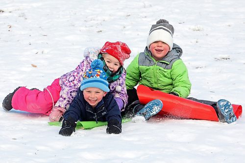 04012024
Barrett Peech, Anna Mahy and Roger Saban laugh while sledding down the hill together at Victoria Park in Souris during an outing for kids at Souris Cooperative Daycare on Thursday. (Tim Smith/The Brandon Sun)