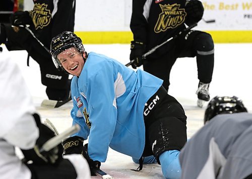 Nate Danielson smiles at his Brandon Wheat Kings teammates as they stretch after practice at centre ice on Friday afternoon. The team captain arrived back in Brandon late Wednesday night after returning from the world junior championship in Sweden. (Photo Perry Bergson/The Brandon Sun)
 