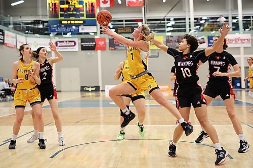 Reetta Tulkki (7) of the Brandon University Bobcats leaps past Jasia Hayden #10 of the University of Winnipeg Wesmen to take a shot on the net during U Sports basketball action at the BU Healthy Living Centre on Friday evening. (Tim Smith/The Brandon Sun)