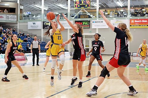 Faith Clearsky (23) of the Brandon University Bobcats leaps to take a shot on the net as Tamiya Ness #6 of the University of Winnipeg Wesmen tries to block during university basketball action at the BU Healthy Living Centre on Friday evening. (Tim Smith/The Brandon Sun)