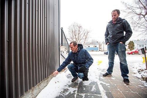 MIKAELA MACKENZIE / WINNIPEG FREE PRESS
	
Cal Dueck, Dueck Builders president (left), and Josh Friesen, Dueck Builders co-owner, show the parging line where concrete was poured to at a house they built (it was constructed when they were lobbying Lafarge to supply low-carbon concrete) on Friday, Jan. 5, 2024. Dueck Builders is among the first to adopt Lafarge Canada&#x573; low-carbon concrete, which comes as the industry tries to reduce its carbon footprint. For Gabby story.
Winnipeg Free Press 2023