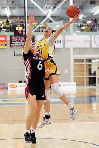 05012024
Faith Clearsky #23 of the Brandon University Bobcats leaps over Tamiya Ness #6 of the University of Winnipeg Wesmen to take a shot on the net during university basketball action at the BU Healthy Living Centre on Friday evening.
(Tim Smith/The Brandon Sun)