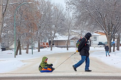 09012024
A man pulls a boy in a sled along Maryland Avenue on a bitterly cold Tuesday. Environment Canada's forecast calls for a balmy high of -8 C today before plunging to a high of -20 C on Thursday. (Tim Smith/The Brandon Sun)