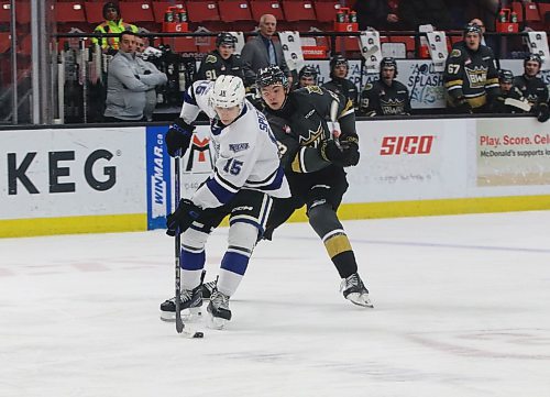 Brandon Wheat Kings forward Roger McQueen (13) pursues Victoria Royals defenceman Ryan Spizawka (15) during Western Hockey League action at Westoba Place on Tuesday. Spizawka managed to get the puck past McQueen and out of the zone. (Perry Bergson/The Brandon Sun)
  