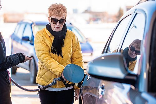 MIKAELA MACKENZIE / WINNIPEG FREE PRESS
	
Cynthia Dutton fills up her tank at the Polo Park Mobil gas station on Friday, Dec. 29, 2023. The gas tax will be paused on Jan. 1st, which should further reduce gas prices. For Danielle story.
Winnipeg Free Press 2023