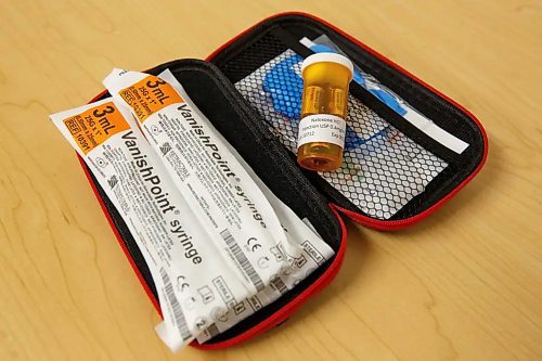 A Naloxone kit that includes four doses, vanish point needles, gloves, a face shield for CPR purposes, and an information card. (Mike Deal/Winnipeg Free Press)