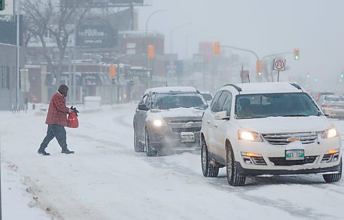 MIKE DEAL / WINNIPEG FREE PRESS
A person crosses Portage Avenue battling blowing snow Thursday morning.
240111 - Thursday, January 11, 2024.