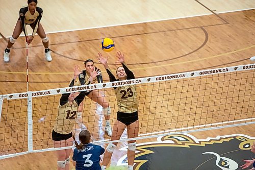 BROOK JONES / WINNIPEG FREE PRESS
The University of Manitoba Bisons hosts the visiting Trinity Western Spartans in Canada West women's volleyball action inside Investors Group Athletic Centre at the University of Manitoba's Fort Garry campus in Winnipeg, Man., Friday, Jan. 12, 2023. The Bisons earned a 3-1 (22-25, 25-18, 25-20, 25-22) victory over the Spartans. Pictured: U of M Bisons settler Katreena Bentley (No. 12) and middle Eva Catojo (No. 23) go up to block the volleyball over the net during fourth set action.
