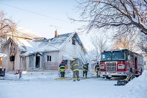 BROOK JONES / WINNIPEG FREE PRESS
Firefighters with Winnipeg Fire Paramedic Service responded to a fire in a two-and-a-half-storey multi-family house in the 100 block of Rex Avenue in Winnipeg, Man., around 11:20 a.m., Sunday, Jan. 14, 2024. By 3:30 p.m. crews were clearing the scene as the house, which was seriously damaged by fire, continued to smolder. Pictured: Firefighter pack up fire hos