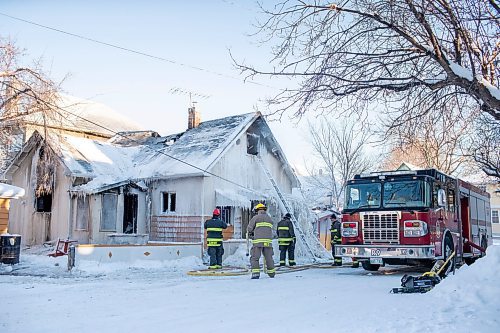 BROOK JONES / WINNIPEG FREE PRESS
Firefighters with Winnipeg Fire Paramedic Service responded to a fire in a two-and-a-half-storey multi-family house in the 100 block of Rex Avenue in Winnipeg, Man., around 11:20 a.m., Sunday, Jan. 14, 2024. By 3:30 p.m. crews were clearing the scene as the house, which was seriously damaged by fire, continued to smolder. Pictured: Firefighter pack up fire hoses. 