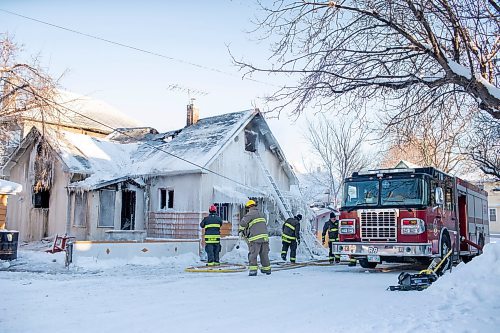 BROOK JONES / WINNIPEG FREE PRESS
Firefighters with Winnipeg Fire Paramedic Service responded to a fire in a two-and-a-half-storey multi-family house in the 100 block of Rex Avenue in Winnipeg, Man., around 11:20 a.m., Sunday, Jan. 14, 2024. By 3:30 p.m. crews were clearing the scene as the house, which was seriously damaged by fire, continued to smolder. Pictured: Firefighter pack up fire hos