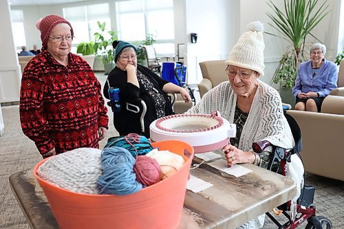 15012024
Denise Earl, a resident at Rotary Villas at Crocus Gardens, knits a toque using a Sentro knitting machine as fellow residents Grace Flynn, Marilyn Ross and Sylvia Barr look on. Flynn and a group of other residents at Rotary Villas knit toques for Samaritan House Ministries. They also make scarves, mitts,  dish cloth&#x2019;s and baby blankets. The knitting machine is a new addition to their workflow, allowing them to make toques much faster.   (Tim Smith/The Brandon Sun)