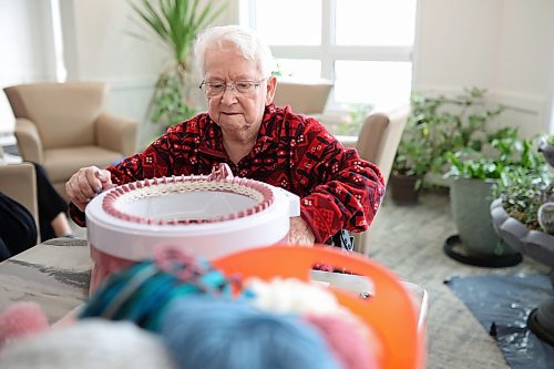 15012024
Grace Flynn, a resident at Rotary Villas at Crocus Gardens, knits a toque using a Sentro knitting machine. Flynn and a group of other residents at Rotary Villas knit toques for Samaritan House Ministries. They also make scarves, mitts,  dish cloth&#x2019;s and baby blankets. The knitting machine is a new addition to their workflow, allowing them to make toques much faster.   (Tim Smith/The Brandon Sun)