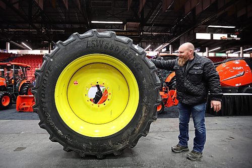 15012024
Jess Cords, Brandon Fountain Tire franchise owner, moves a tire while setting up the Fountain Tire display for Manitoba Ag Days 2024 at the Keystone Centre on Monday. Ag Days begins today and runs until Thursday. (Tim Smith/The Brandon Sun)