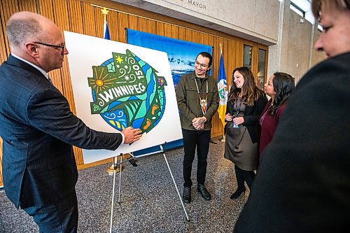 MIKAELA MACKENZIE / WINNIPEG FREE PRESS
	
Artist Jordan Stranger and mayor, councillors, and staff take a look at the new Winnipeg 150 graphic at City Hall on Monday, Jan. 15, 2024. For Tyler story.
Winnipeg Free Press 2023