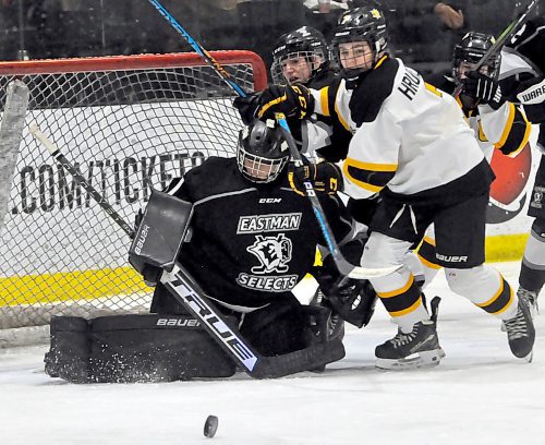 Following a loose puck off an initial shot during second period action, Brandon Wheat King forward Londyn Hrubeniuk (7) brushes Eastman Select goalie Isabelle Laboissiere in the crease. The first-place Select skated to a 4-1 victory at J&G Homes Arena. (Jules Xavier/The Brandon Sun)