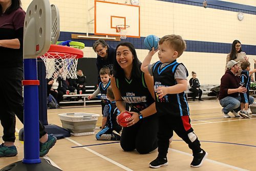 Little Ballers coach Zaina Bird, left, watches as Beau Young shoots during the two-and-a-half to three-and-a-half-year-old session at Waverly Park School on Saturday. The program is open to kids ages 10 months to eight years old. (Thomas Friesen/The Brandon Sun)