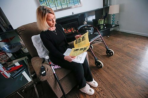 JOHN WOODS / WINNIPEG FREE PRESS
Cynthia Carr reads her post-op notes from Concordia Hip and Knee centre as she sits with her walker and cane in her home in Winnipeg Monday, January 16, 2024. Carr had a hip replaced on December 28/23 after a year of unrelenting pain. 

Reporter: ?