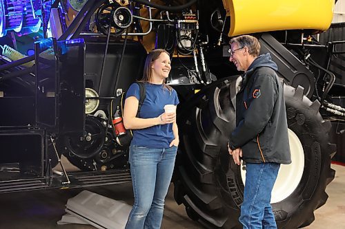 Sara Tufts and her dad Bruce Miller - both farmers, share a laugh as they talk about which brand of farm equipment they think does a better job, at Manitoba Ag Days held in the Keystone Centre, which wrapped up on Thursday. (Michele McDougall/The Brandon Sun)