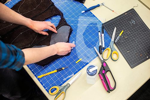 MIKAELA MACKENZIE / WINNIPEG FREE PRESS
	
Folks cut out pattern pieces at a mitt making workshop at the Millennium Library ideaMILL on Thursday, Jan. 18, 2024. The mitts, which are made using re-purposed leather and fur coats, will be donated to an agency for community members in need.  Standup.
Winnipeg Free Press 2024