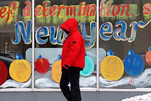 18012024
A bundled up pedestrian walks past a Happy New Year window mural outside Adult &amp; Teen Challenge Super Thrift Brandon on 7th Street on a cold Thursday. (Tim Smith/The Brandon Sun)