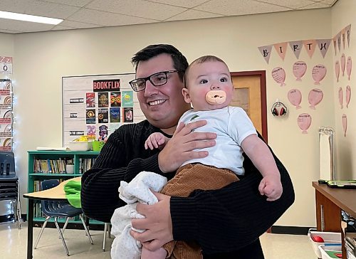 Brendan Christianson and his baby, August &#x2014; a &#x201c;tiny teacher&#x201d; at Lavallee School &#x2014; are regular visitors at the elementary school as part of its Roots of Empathy program. MAGGIE MACINTOSH/WINNIPEG FREE PRESS 