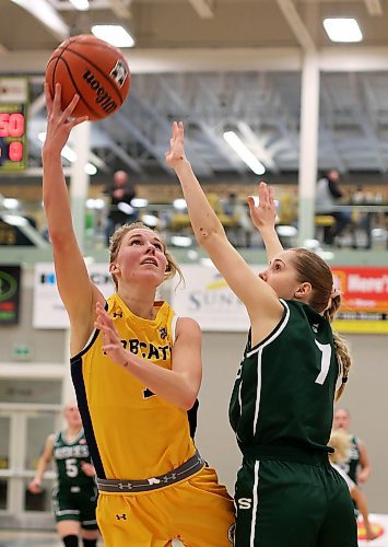 19012024
Reetta Tulkki #7 of the Brandon University Bobcats leaps to let off a shot on the net as Andrea Dodig #7 of the University of Saskatchewan Huskies tries to block during university women&#x2019;s basketball action at the BU Healthy Living Centre on Friday evening. 
(Tim Smith/The Brandon Sun)