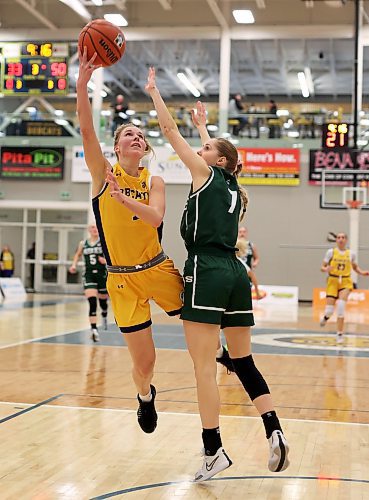 19012024
Reetta Tulkki #7 of the Brandon University Bobcats leaps to let off a shot on the net as Andrea Dodig #7 of the University of Saskatchewan Huskies tries to block during university women&#x2019;s basketball action at the BU Healthy Living Centre on Friday evening. 
(Tim Smith/The Brandon Sun)