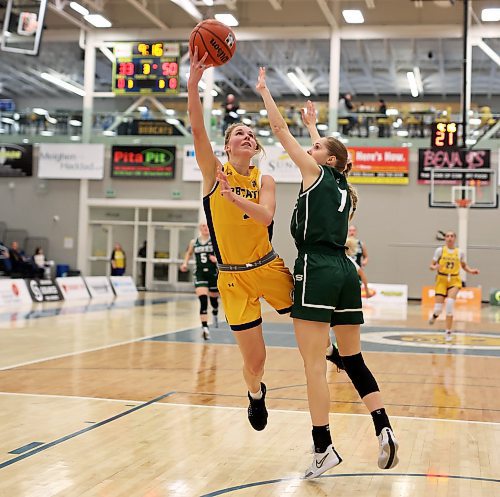 19012024
Reetta Tulkki #7 of the Brandon University Bobcats leaps to let off a shot on the net as Andrea Dodig #7 of the University of Saskatchewan Huskies tries to block during university women&#x2019;s basketball action at the BU Healthy Living Centre on Friday evening. 
(Tim Smith/The Brandon Sun)