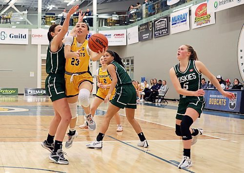 19012024
Faith Clearsky #23 of the Brandon University Bobcats leaps for a shot on the net as Carly Ahlstrom #3 of the University of Saskatchewan Huskies tries to block during university women&#x2019;s basketball action at the BU Healthy Living Centre on Friday evening. 
(Tim Smith/The Brandon Sun)