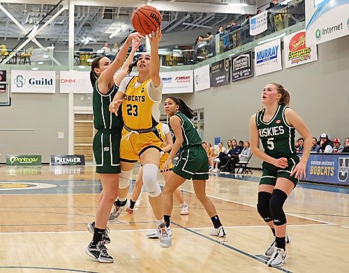 19012024
Faith Clearsky #23 of the Brandon University Bobcats leaps for a shot on the net as Carly Ahlstrom #3 of the University of Saskatchewan Huskies tries to block during university women&#x2019;s basketball action at the BU Healthy Living Centre on Friday evening. 
(Tim Smith/The Brandon Sun)