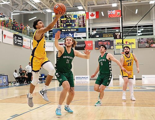 19012024
Dominique Dennis #6 of the Brandon University Bobcats leaps for a shot on the net past Ryker Wuttke #11 of the University of Saskatchewan Huskies during university men&#x2019;s basketball action at the BU Healthy Living Centre on Friday evening. 
(Tim Smith/The Brandon Sun)