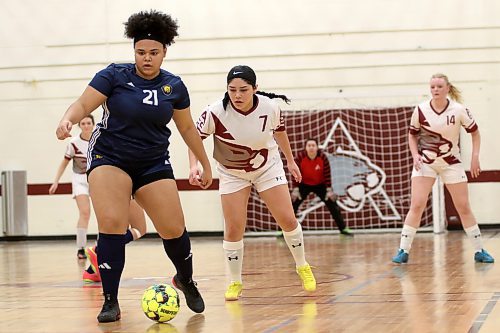 Brandon University Bobcats Deja Newell (21) controls the ball with ACC's Elsy Benitez defending during MCAC women's futsal action at ACC on Saturday. Brandon prevailed 11-1. (Thomas Friesen/The Brandon Sun)