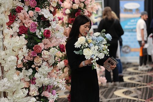 Sheryl Stodomingo of Weddings by Abby checks out a Wedding Expo schedule while she waits for customers. The Westman Wedding Expo was held Sunday at the Victoria Inn. (Kyla Henderson/The Brandon Sun)
