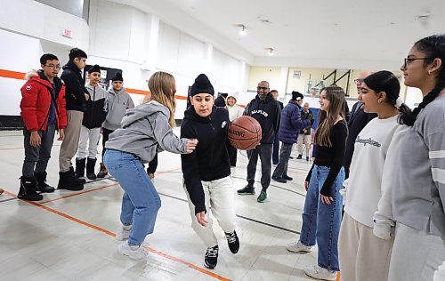 RUTH BONNEVILLE / WINNIPEG FREE PRESS

Standup - basketball fun with Mayor and council members

Harmanjit Singh of Arthur E. Wright School, plays a fun, pick-up-game of basketball against fellow student, Olha Durniak, at Maples Community Centre after city's funding announcement Monday.

Grades 7 &amp; 8 students from Arthur E. Wright School and community members attended the announcement which is awarding renovation grants to 13 community centres in the city including a new gym floor for  Maples Community Centre.

All in attendance:
Mayor Scott Gillingham
Evan Duncan, Chairperson of the Standing Policy Committee on Community Services
Devi Sharma, Councillor for Old Kildonan
Lora Meseman, Executive Director, General Council of Winnipeg Community Centres
 



Jan 22nd 2024